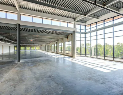 The perimeter walls are constructed of precast concrete with a structural steel framing system. The exterior finish is a combination of painted precast and EIFS, with storefront and curtainwall. Designed to spark connection and creativity, the building’s open floor plans with virtually column-free layouts provide flexible interior design complete with natural light and tree-lined views.